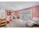 Stylish living room with pink walls, modern decor, and lots of natural light at 2706 Colanthe Ave, Las Vegas, NV 89102