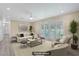 Bright, staged living room featuring neutral tones, modern decor, and sliding glass doors at 2706 Colanthe Ave, Las Vegas, NV 89102