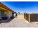 Low-maintenance backyard with gravel, defined by a modern fence and home's exterior, offers potential for customization at 271 E Shelbourne Ave, Las Vegas, NV 89123