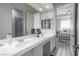 Bright primary bathroom with dual sinks, lots of counter space, and entry to bedroom at 271 E Shelbourne Ave, Las Vegas, NV 89123