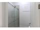 En suite bathroom featuring a tiled shower with sliding glass doors and white fixtures at 271 E Shelbourne Ave, Las Vegas, NV 89123