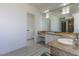 Bright bathroom with double sinks, white cabinetry, and an open doorway to a powder room for convenience and style at 271 E Shelbourne Ave, Las Vegas, NV 89123