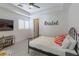 Charming bedroom with modern accents, featuring a comfortable bed, ceiling fan, and trendy decor at 271 E Shelbourne Ave, Las Vegas, NV 89123