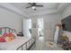 Bright bedroom offering ample space, wood-like flooring, natural light and a view into an ensuite bathroom at 271 E Shelbourne Ave, Las Vegas, NV 89123