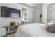 Bright bedroom boasts a TV, mirrored side table, and modern furniture at 271 E Shelbourne Ave, Las Vegas, NV 89123