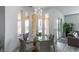 Dining area with glass table, gray upholstered chairs, views of pool and outdoor space at 271 E Shelbourne Ave, Las Vegas, NV 89123