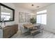 Modern dining room featuring hardwood floors, a stylish light fixture, a wooden table, and contemporary decor at 271 E Shelbourne Ave, Las Vegas, NV 89123