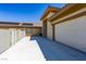 Long driveway leading to a multi-car garage with a well-maintained exterior and a view of solar panels at 271 E Shelbourne Ave, Las Vegas, NV 89123