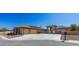 Expansive single-story home showcasing a neutral color palette, complemented by a spacious driveway and well-manicured landscaping at 271 E Shelbourne Ave, Las Vegas, NV 89123