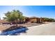 Beautiful home exterior with desert landscaping and a tile roof, showcasing its attractive curb appeal and style at 271 E Shelbourne Ave, Las Vegas, NV 89123