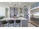 Well-lit kitchen featuring an island, stainless steel appliances, and gray cabinetry at 271 E Shelbourne Ave, Las Vegas, NV 89123