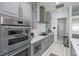 Gourmet kitchen with stainless steel oven and cooktop, sleek gray cabinets, and ample counter space at 271 E Shelbourne Ave, Las Vegas, NV 89123