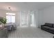 Bright and airy living room with hardwood floors, a modern sofa, and natural light from a large window at 271 E Shelbourne Ave, Las Vegas, NV 89123