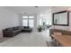 Bright living room features tile flooring, large windows, and a comfortable gray couch at 271 E Shelbourne Ave, Las Vegas, NV 89123