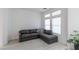 Bright and airy living room with hardwood floors and a modern gray sectional sofa at 271 E Shelbourne Ave, Las Vegas, NV 89123