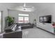 Bright living area with stylish furnishings, featuring a comfortable grey couch, sleek white entertainment center and views of the outdoors at 271 E Shelbourne Ave, Las Vegas, NV 89123