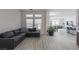 Open-concept living room with a contemporary design, neutral color palette and wood-look tile flooring throughout at 271 E Shelbourne Ave, Las Vegas, NV 89123