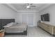 Serene bedroom with tray ceiling, neutral palette, light wood-look floors, and sliding glass door to outdoor space at 271 E Shelbourne Ave, Las Vegas, NV 89123