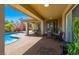 Inviting covered patio with stylish furniture, offering a serene outdoor living space and pool view at 271 E Shelbourne Ave, Las Vegas, NV 89123