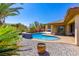 Serene backyard pool and patio area with vibrant greenery, ideal for enjoying sunny days at 271 E Shelbourne Ave, Las Vegas, NV 89123