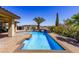 Backyard pool and spa area surrounded by tropical plants and palm trees at 271 E Shelbourne Ave, Las Vegas, NV 89123