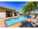 Beautiful backyard pool area with desert landscaping and blue tile water feature under a clear sky at 271 E Shelbourne Ave, Las Vegas, NV 89123