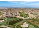 Extensive aerial view of Sun City Anthem with golf course, pond, and neighborhood at 2752 Fort Myer Ave, Henderson, NV 89052