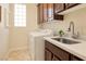 Functional laundry room featuring a sink, countertop, washer, and dryer at 2752 Fort Myer Ave, Henderson, NV 89052