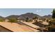 View of neighborhood rooftops with palm trees set against a backdrop of mountains under a clear, sunny sky at 2752 Fort Myer Ave, Henderson, NV 89052