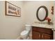 Charming powder room showcasing a decorative mirror, granite countertop, and a toilet at 2752 Fort Myer Ave, Henderson, NV 89052