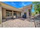 Spacious backyard featuring a brick patio with a dining set and grill, ideal for outdoor living at 2805 Hanging Rock Dr, Las Vegas, NV 89134
