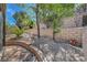Scenic backyard showcases tiered landscaping, rock features, and gravel areas, offering a serene outdoor experience at 2805 Hanging Rock Dr, Las Vegas, NV 89134