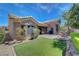 Expansive backyard with artificial turf and landscaped features provides a tranquil and inviting outdoor space at 2805 Hanging Rock Dr, Las Vegas, NV 89134