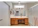 Bathroom features a spacious vanity with honey-colored cabinetry and a decorative stained glass window at 2805 Hanging Rock Dr, Las Vegas, NV 89134