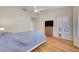 Bedroom featuring wood floors, a television, and a white ceiling fan at 2805 Hanging Rock Dr, Las Vegas, NV 89134