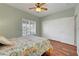 Bright bedroom features light green walls, ceiling fan, and white closet doors at 2805 Hanging Rock Dr, Las Vegas, NV 89134