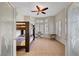 Bedroom with tile flooring, a ceiling fan, large windows, and a bunk bed at 2805 Hanging Rock Dr, Las Vegas, NV 89134