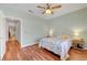 Bedroom featuring wood floors, ceiling fan, and a door to another area of the house at 2805 Hanging Rock Dr, Las Vegas, NV 89134