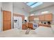 Bright, open kitchen with white appliances, wood-look flooring, and ample counter space with light wood cabinetry at 2805 Hanging Rock Dr, Las Vegas, NV 89134