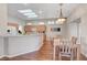 Well-lit eat-in kitchen featuring stainless steel appliances, wood-look flooring, and a modern lighting fixture at 2805 Hanging Rock Dr, Las Vegas, NV 89134