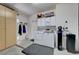 Laundry room featuring a washer and dryer, storage cabinets, and utility sink for added convenience at 2805 Hanging Rock Dr, Las Vegas, NV 89134