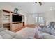 Bright living room features hardwood floors, a large entertainment center, and comfortable seating area at 2805 Hanging Rock Dr, Las Vegas, NV 89134