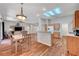 Open-concept living space with hardwood floors, dining area, living room, and a peek into the kitchen at 2805 Hanging Rock Dr, Las Vegas, NV 89134