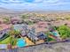 Panoramic aerial view of the property, highlighting the pool, solar panels, and surrounding community at 2820 Sisteron Ct, Henderson, NV 89044