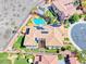 Expansive aerial view of a luxurious house featuring a swimming pool, lush landscaping, and solar panels at 2820 Sisteron Ct, Henderson, NV 89044