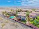 Aerial view of a desert home featuring a custom pool, lush landscaping, and stunning mountain views at 2820 Sisteron Ct, Henderson, NV 89044