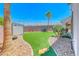 Manicured backyard oasis with synthetic grass and desert landscaping at 2820 Sisteron Ct, Henderson, NV 89044