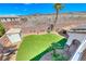 Manicured backyard oasis with synthetic grass and desert landscaping at 2820 Sisteron Ct, Henderson, NV 89044