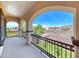 An ornate balcony overlooks manicured green grass and neighborhood homes with mountains in the distance at 2820 Sisteron Ct, Henderson, NV 89044