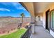 Balcony view of palm trees, an artificial lawn, and a mountain range at 2820 Sisteron Ct, Henderson, NV 89044
